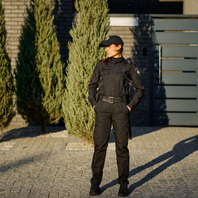 Woman police officer on street full-length portrait. Territory protection, city traffic control